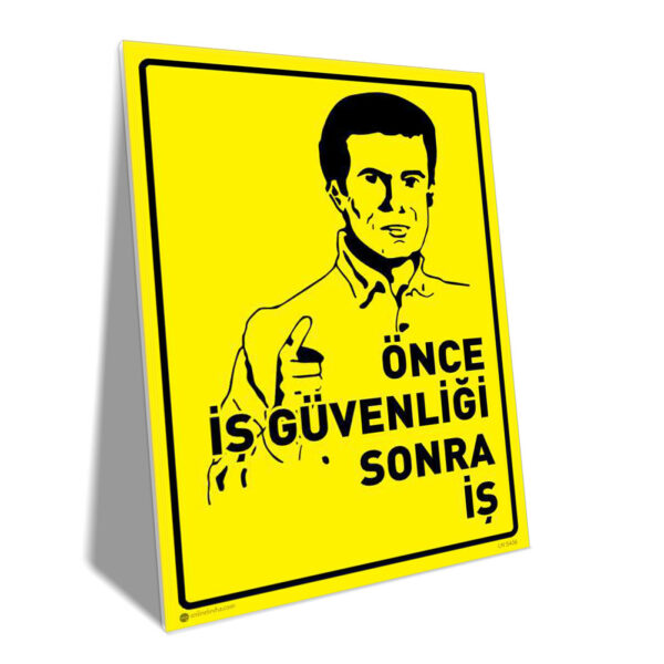 Yellow warning poster showing a man pointing, with bold Turkish text: 'Önce iş güvenliği sonra iş' (safety first, then work)